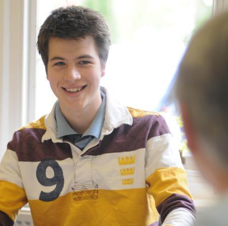 Male student smiling in classroom
