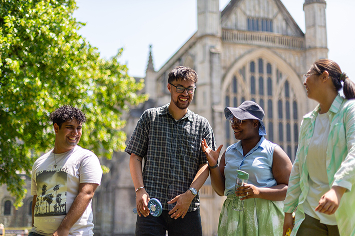 Happy students outside cathedral