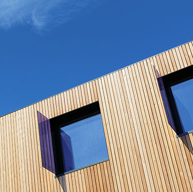 Wood panel cladding on a building on a sunny day
