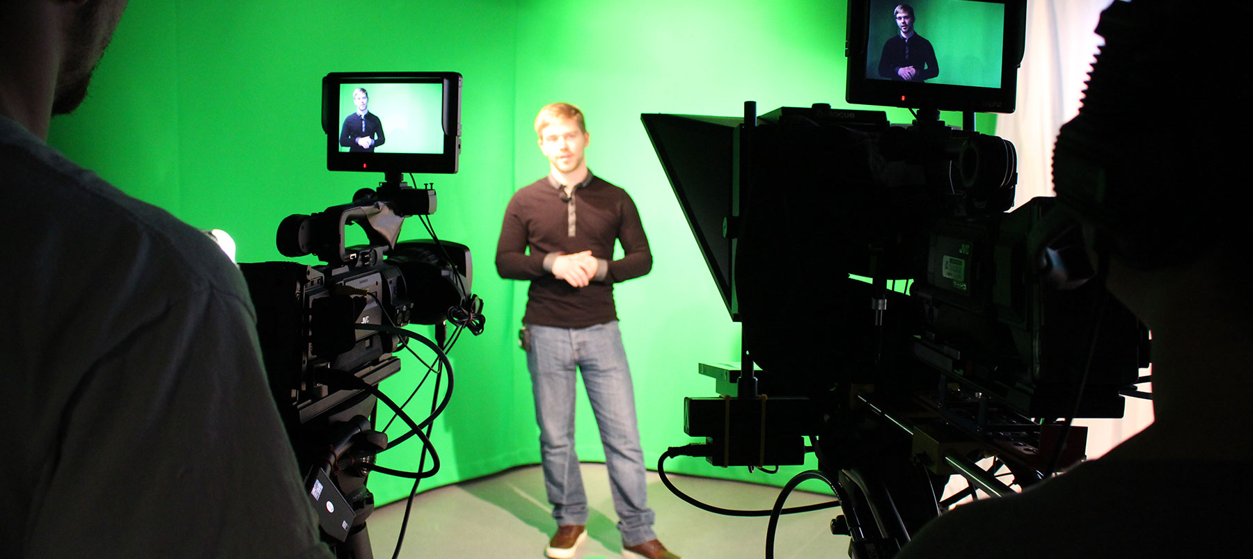 Student performing in a studio with film cameras