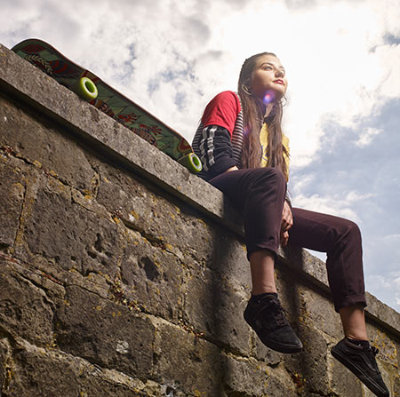 Student sitting on a wall