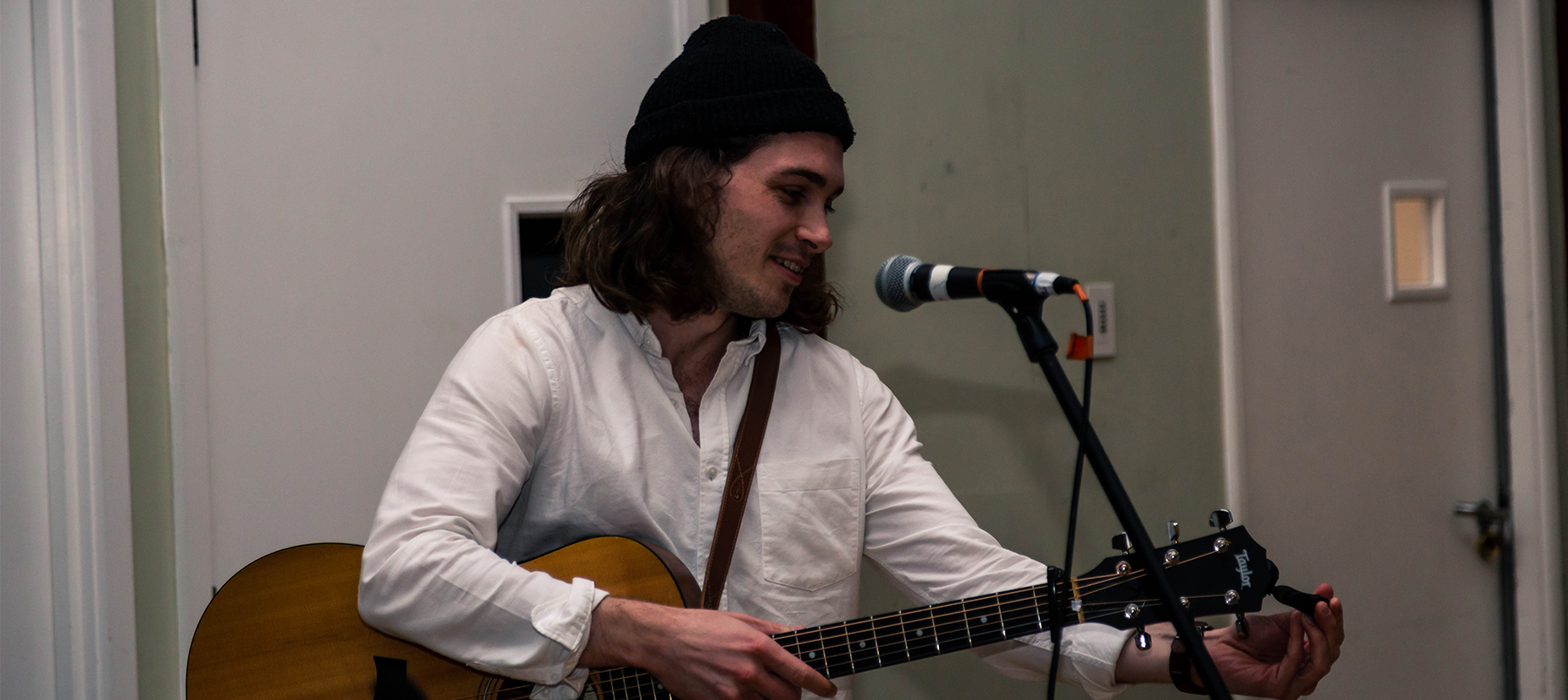 Graduate at microphone playing piano