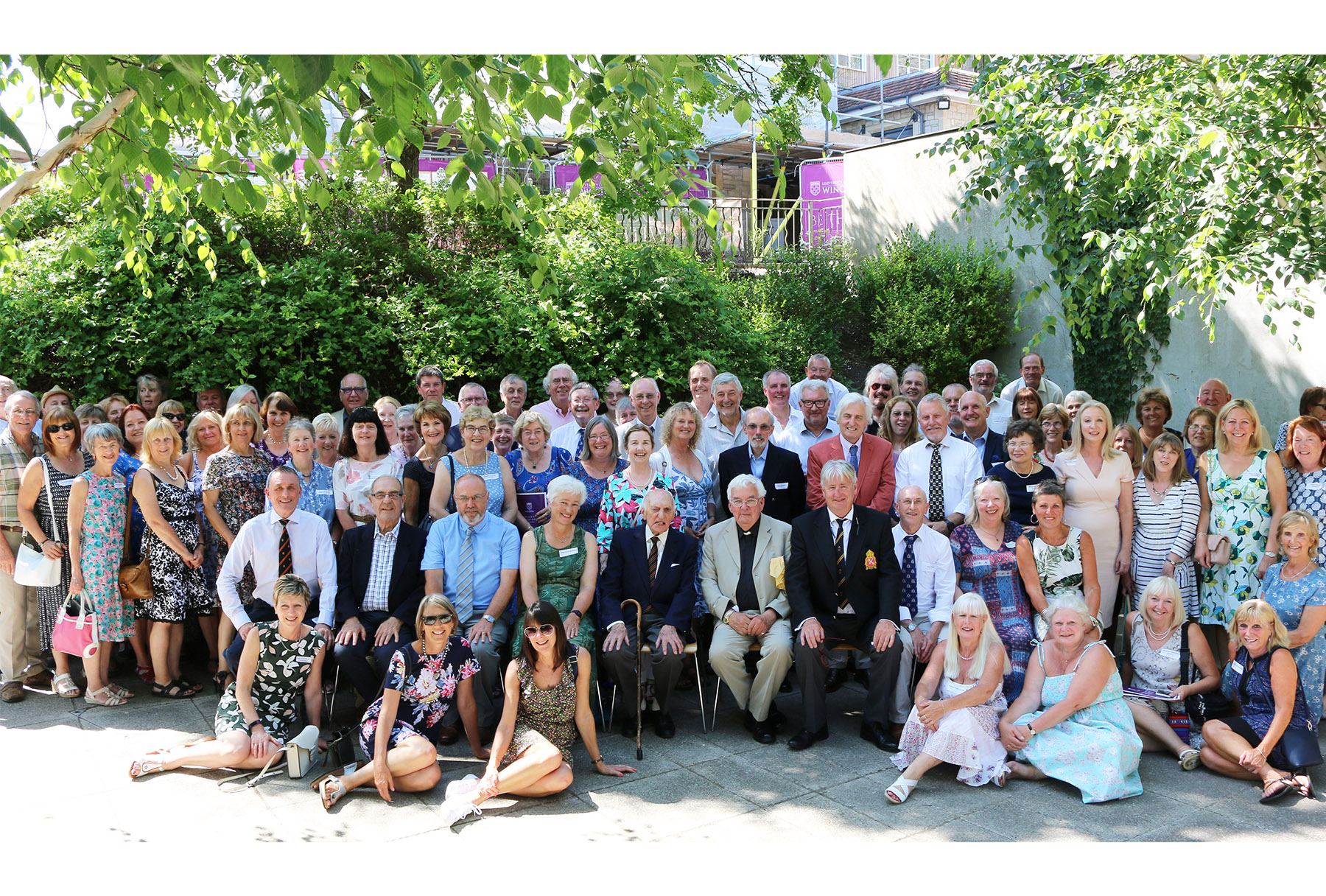 Group of alumni with former Principal outside at Reunion