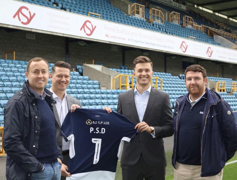 Four men in a football stadium