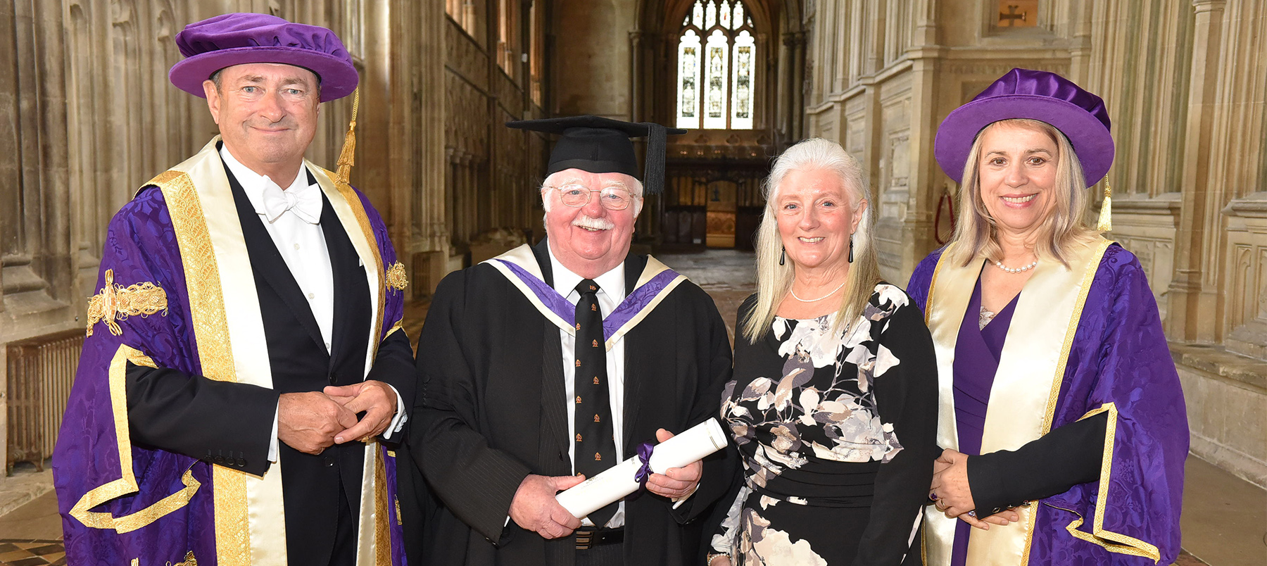 Four people standing in cathedral