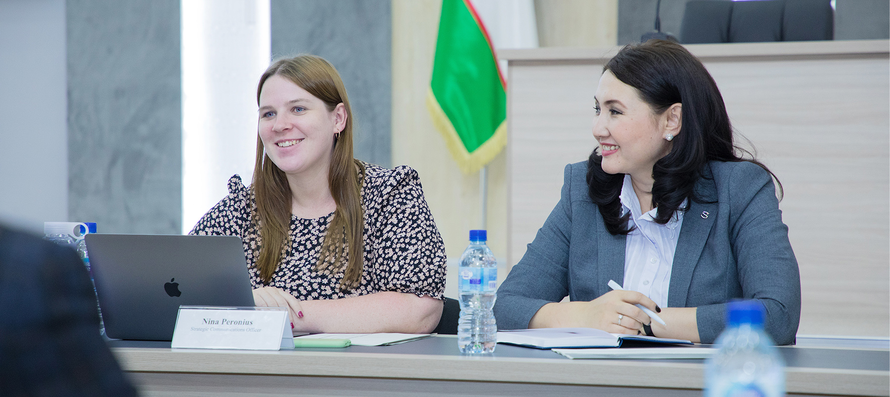 Two women sitting at a conference desk