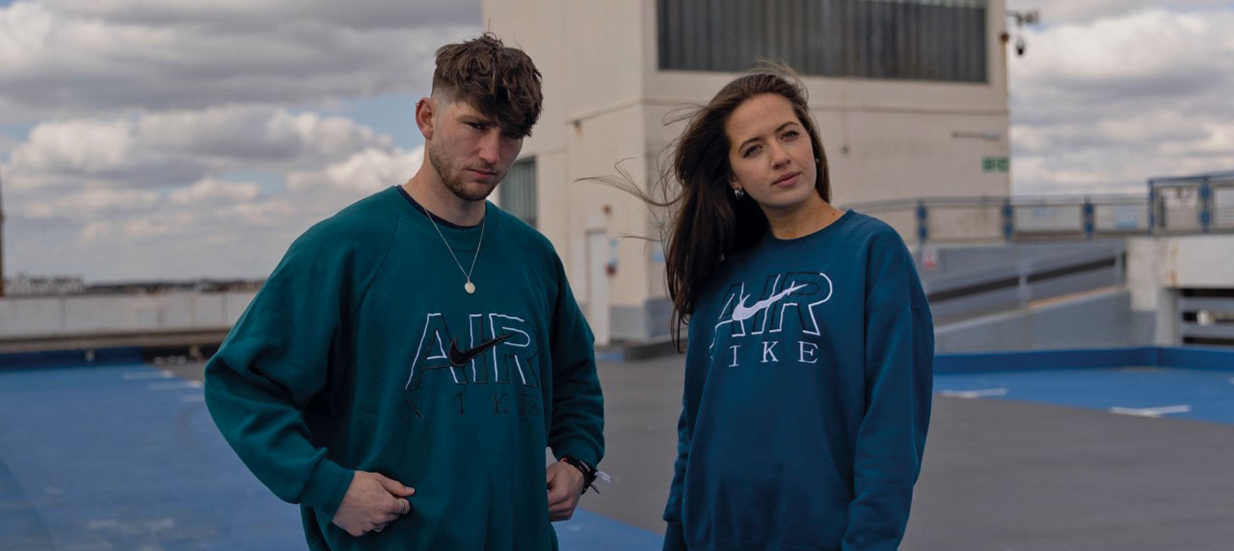 A man and a woman in blue sports clothing