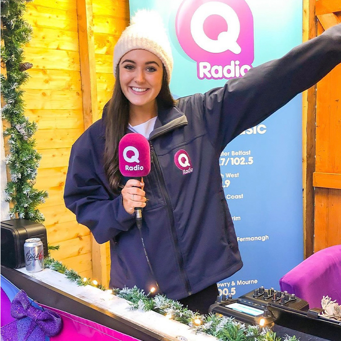 A woman sitting at a radio desk