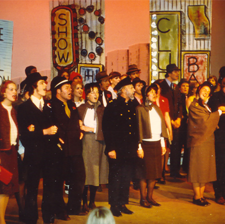 Cast members on stage singing