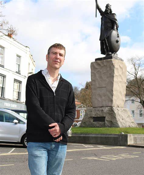 Professor Ryan Lavelle standing in front of the King Alfred Statue