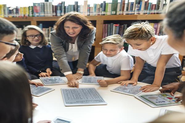 Photo of teacher talking to a group of young students