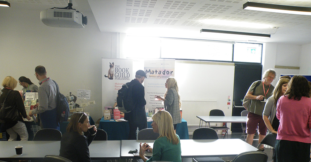 Festival information stands with people talking