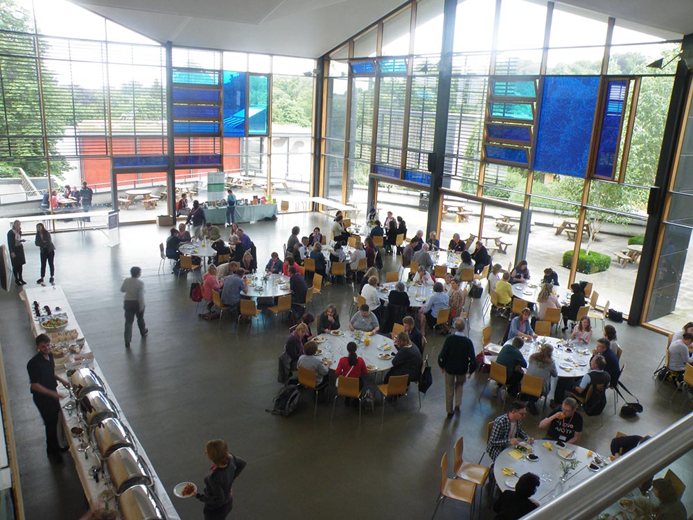 Groups of people eating lunch on shared round table