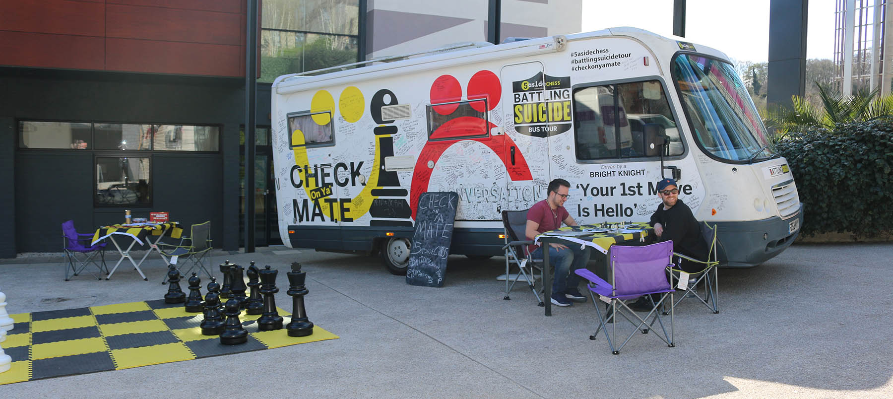 5asideCHESS bus beside two people playing chess at University of Winchester