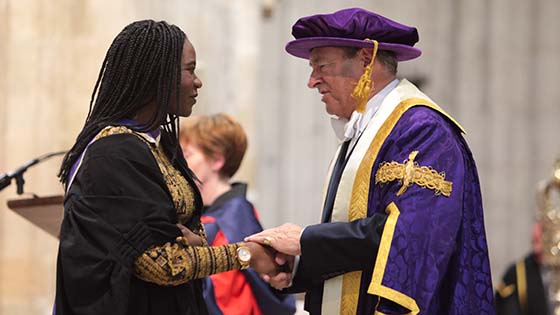 Alan Titchmarsh shakes the hand of a female student at a Graduation ceremony