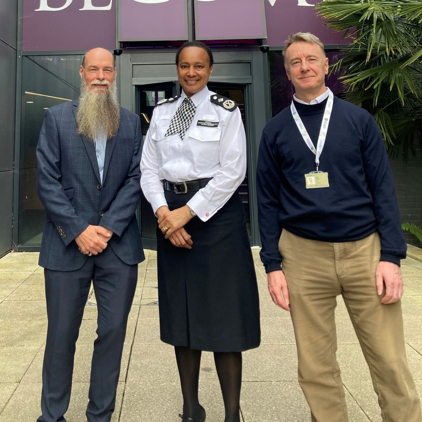 Female police officer flanked by two men