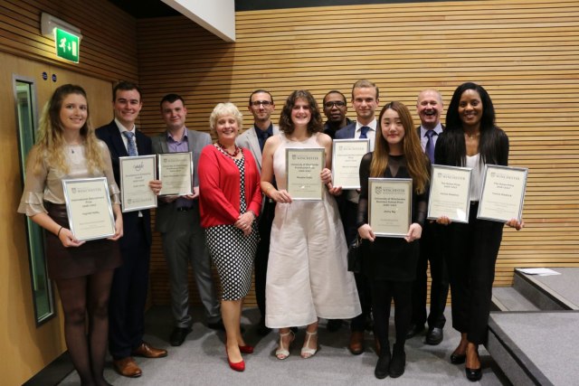 group of students pose with their prize certificates