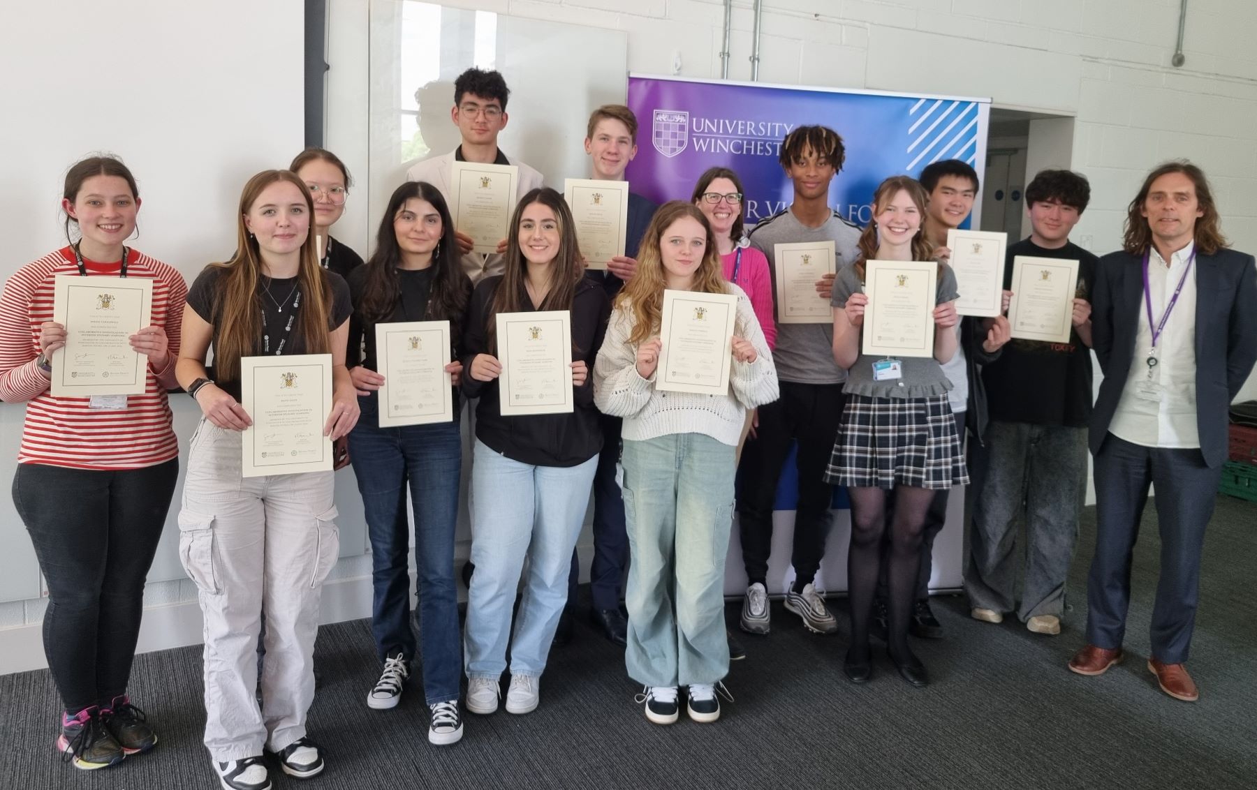 Line up on teenagers with certificates