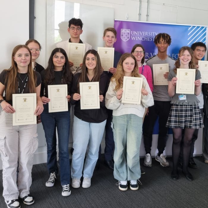 Line up on teenagers with certificates