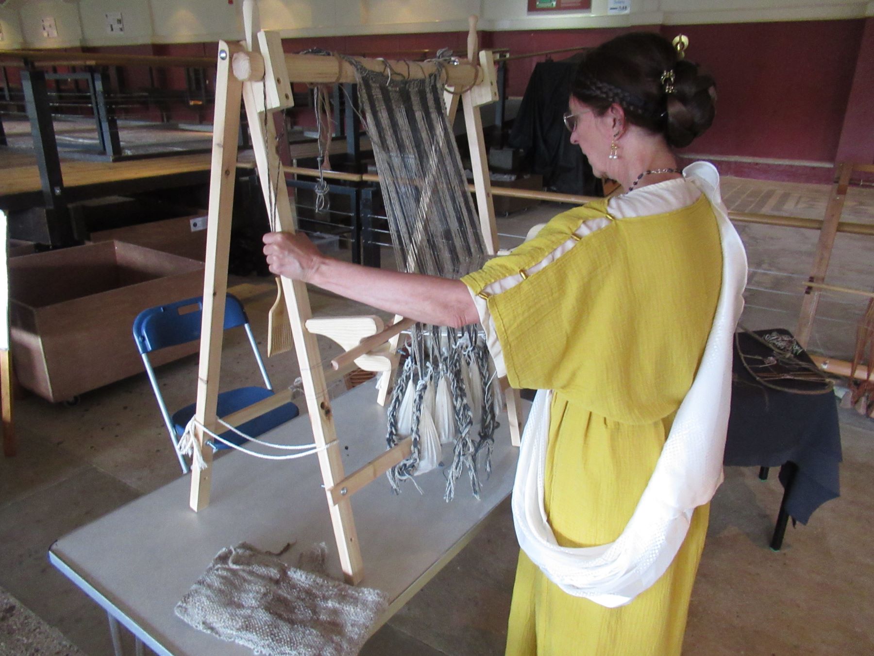 woman in yellow dress spinning yarn