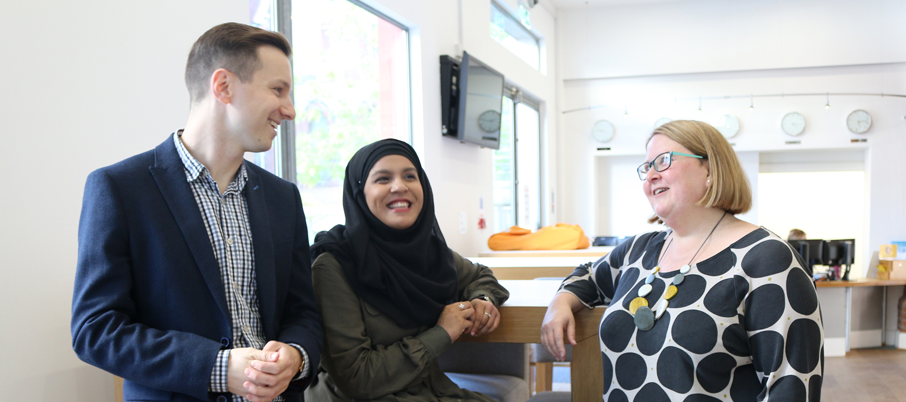 Three members of the Centre standing chatting to each other