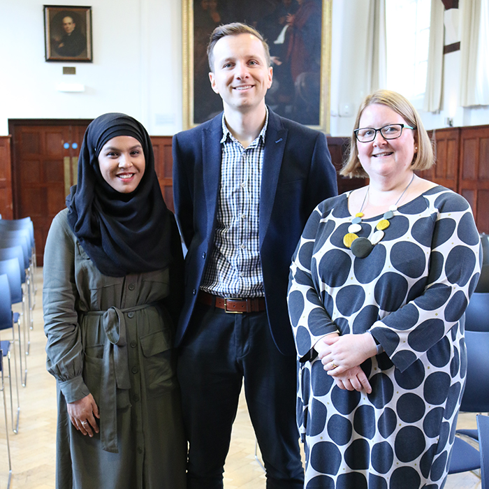 Three members of the Centre standing chatting to each other