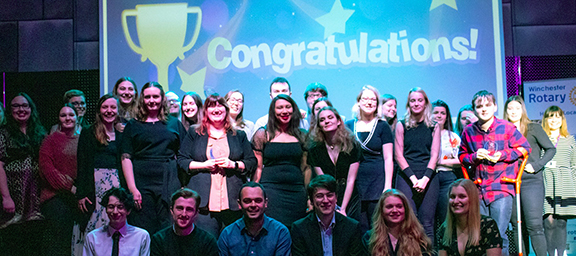 Large group of student volunteers on stage at the awards ceremony