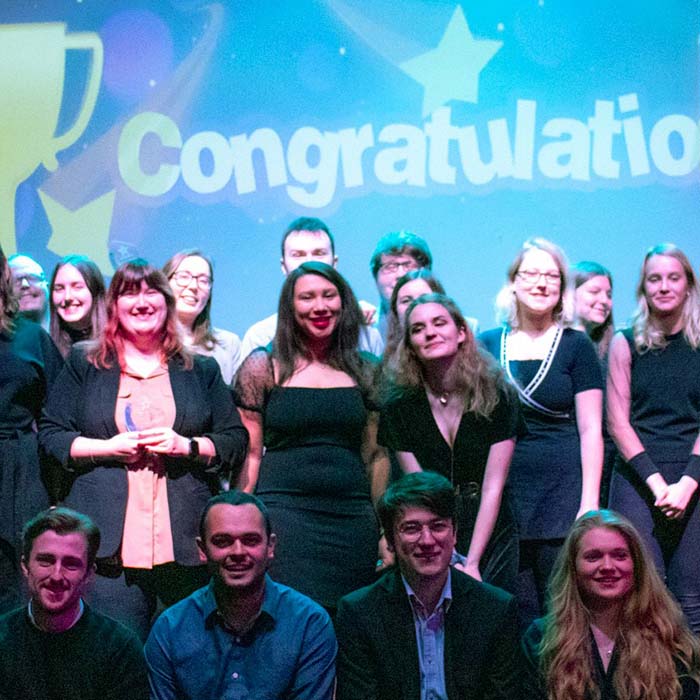 Large group of student volunteers on stage at the awards ceremony