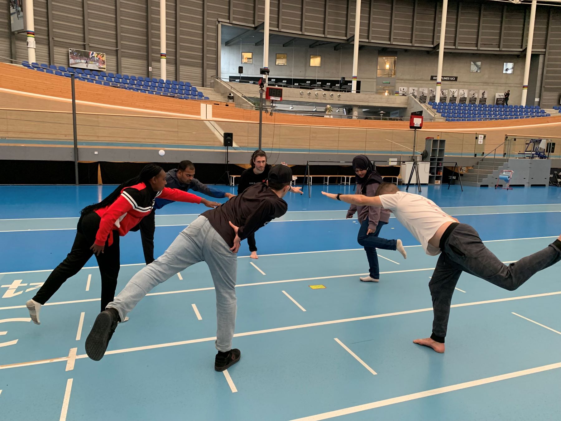 People standing on one leg in yoga session