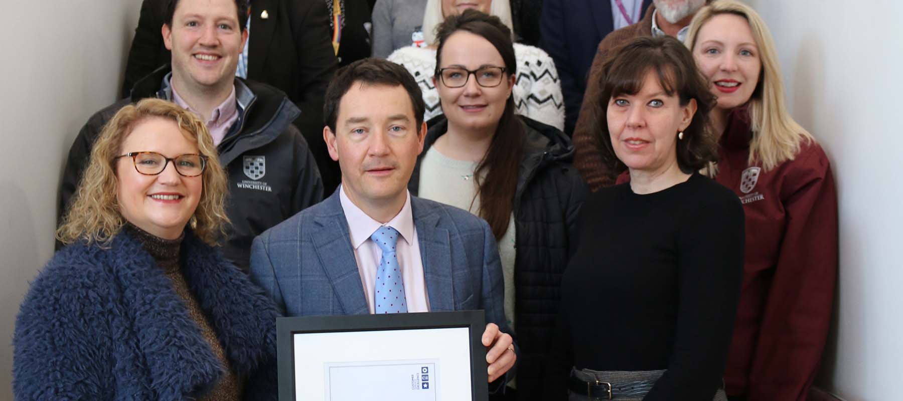 Estates and Facilities staff with their framed award certificate