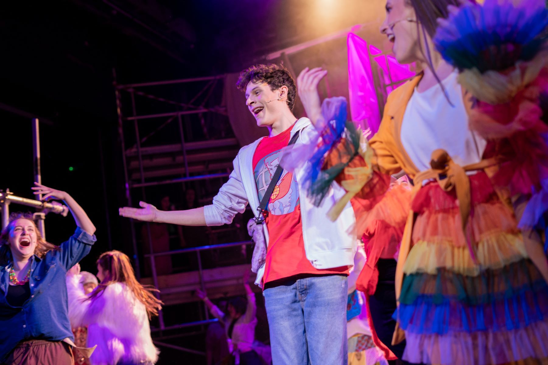 musical theatre student performing on stage in bright colours