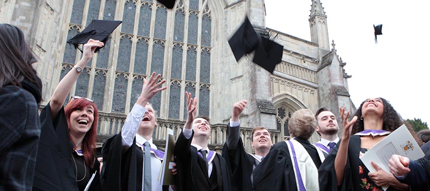 Students celebrating graduation outside the Cathedral