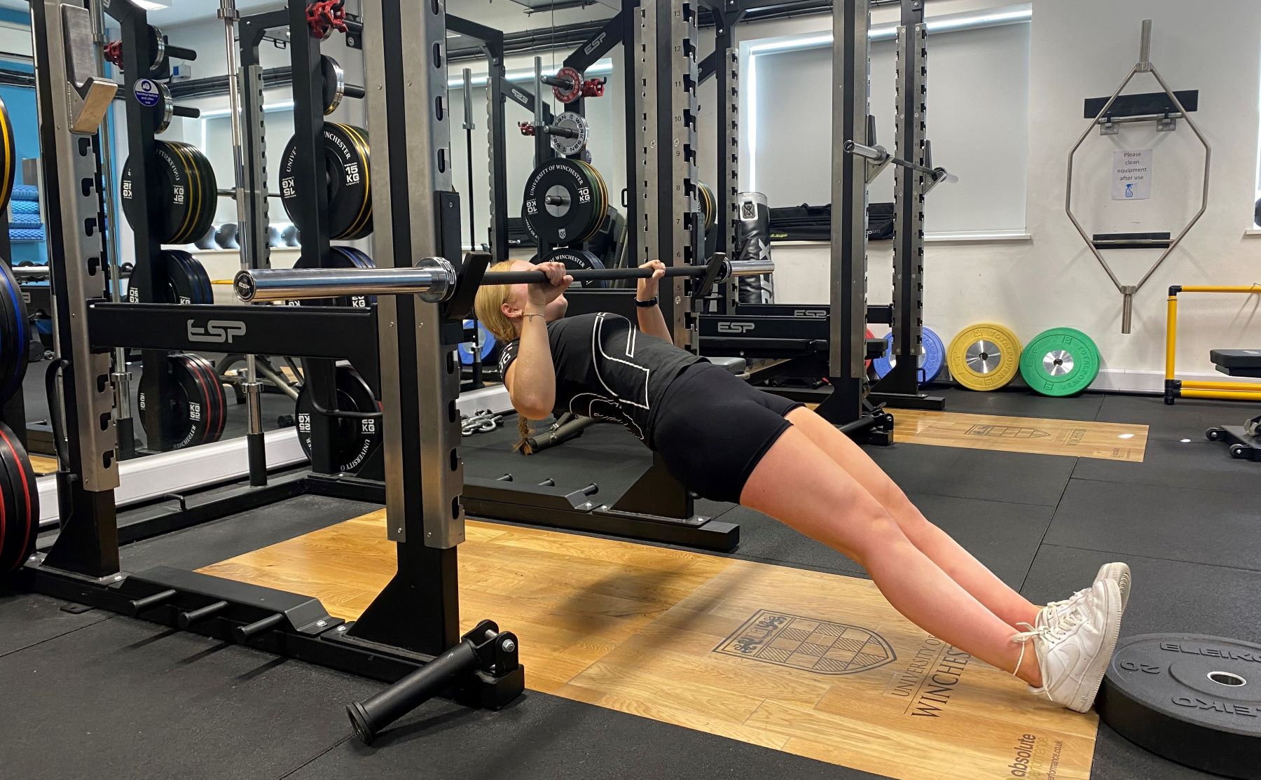 Girl in gym doing pull ups