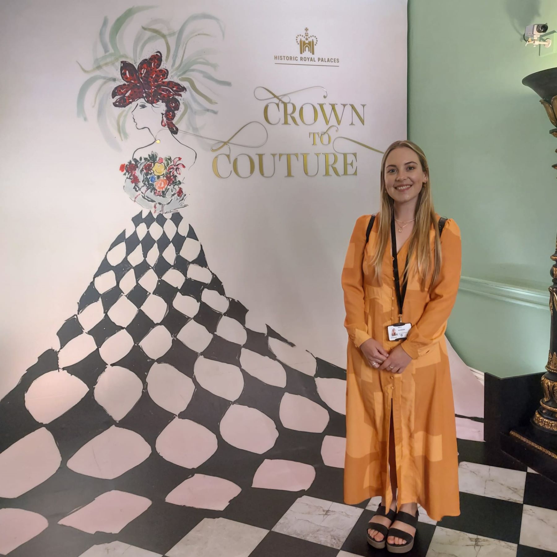 wom,an stood in front of crown to couture poster