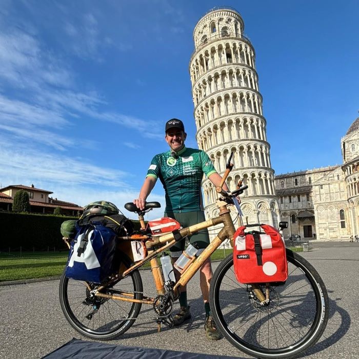 Cyclist in front of Leaning Tower of Pisa
