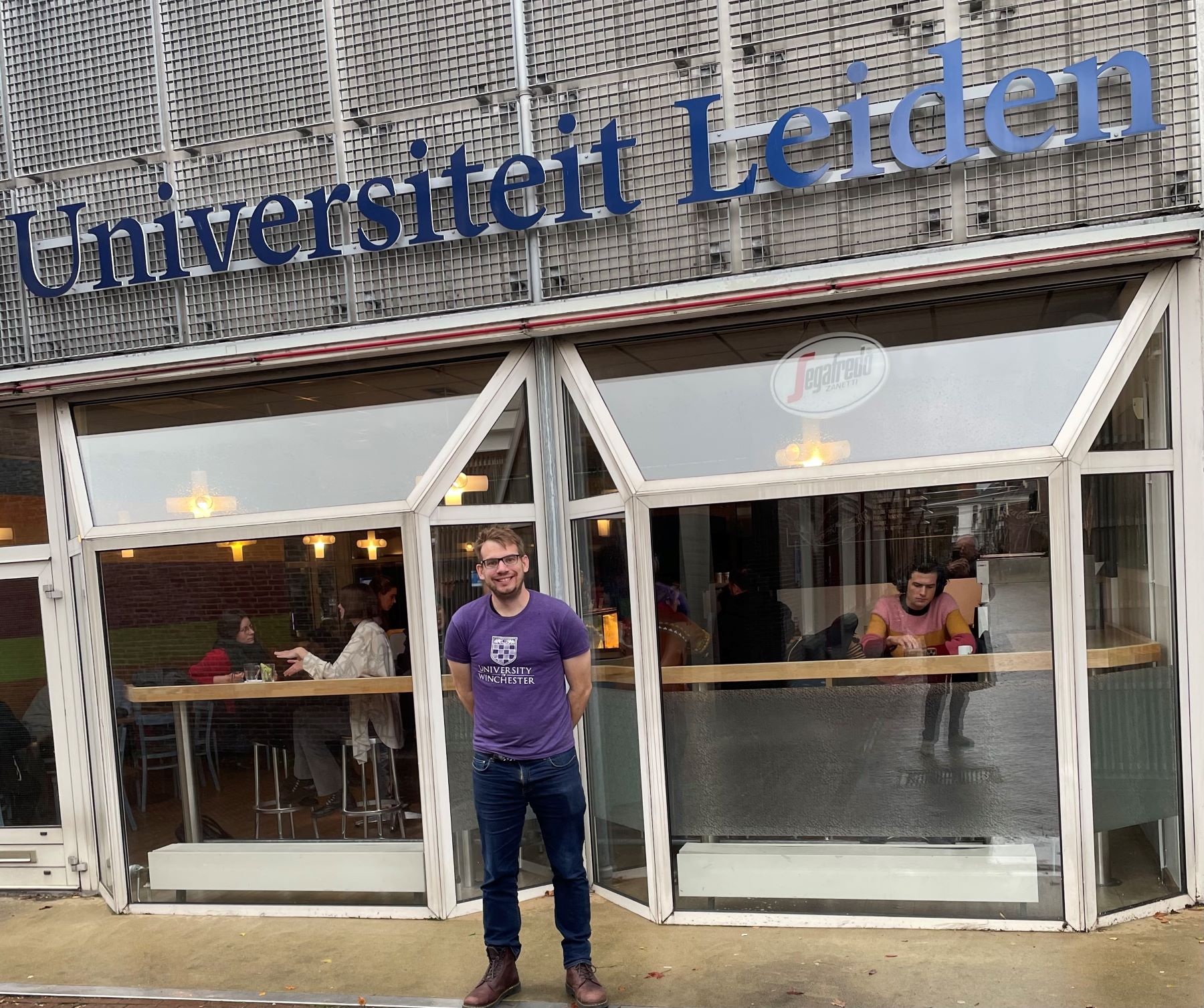 Bearded man standing outside Leiden University building