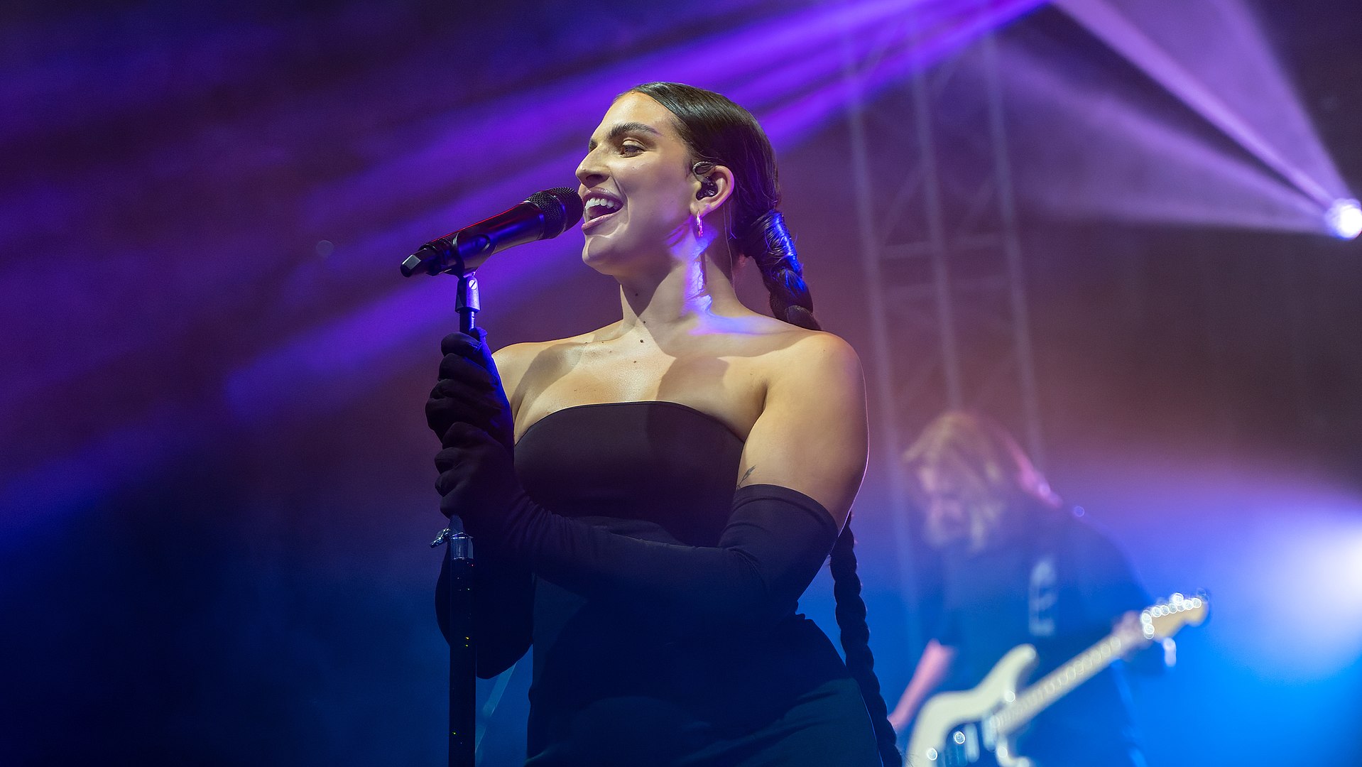 Female singer in dark strapless dress