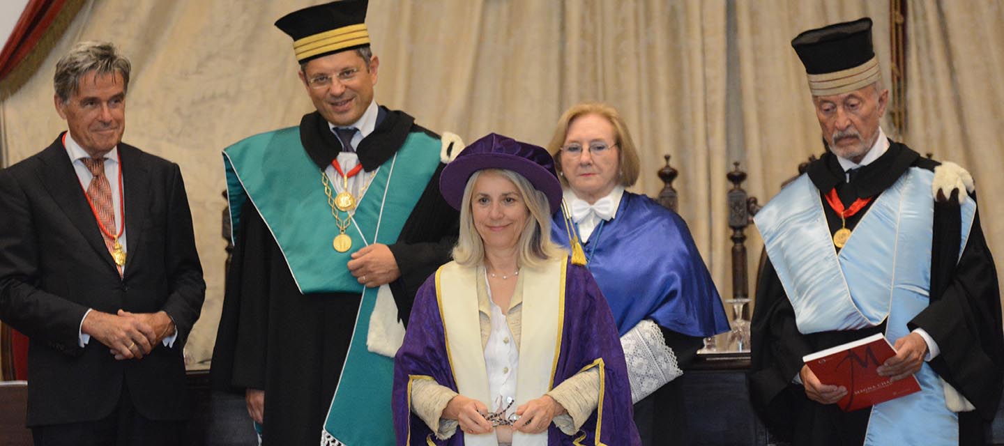 Group of five people in ceremonial dress at signing ceremony