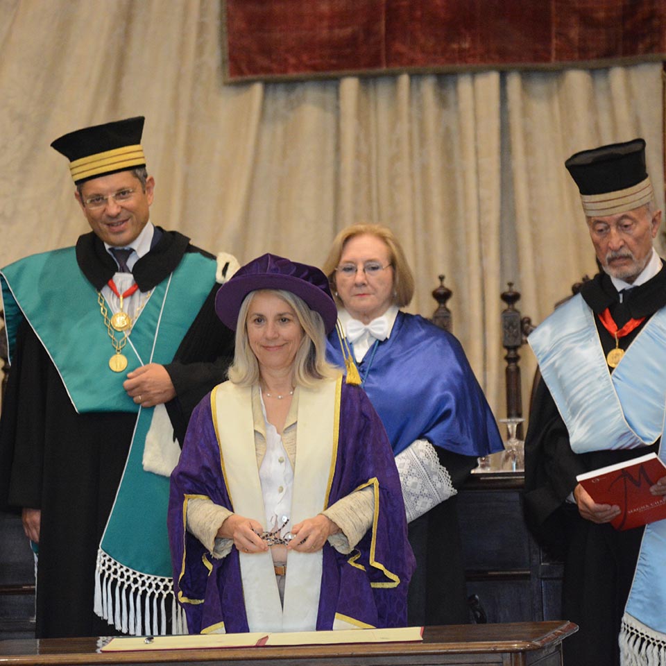 Group of five people in ceremonial dress at signing ceremony