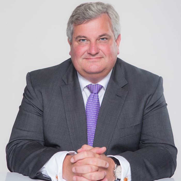 Man in suit standing in posh street