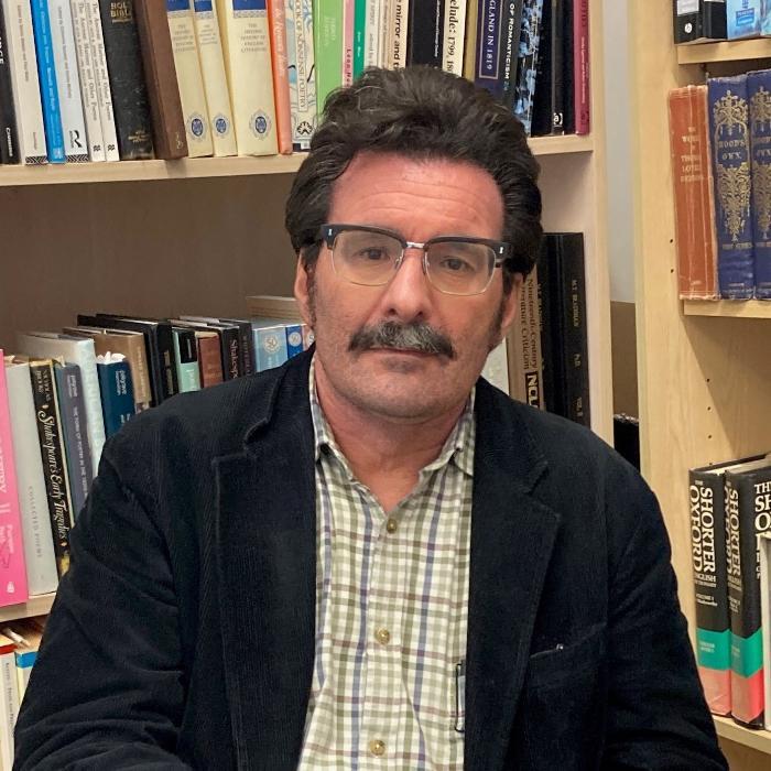 man with dark, hair glasses and moustache