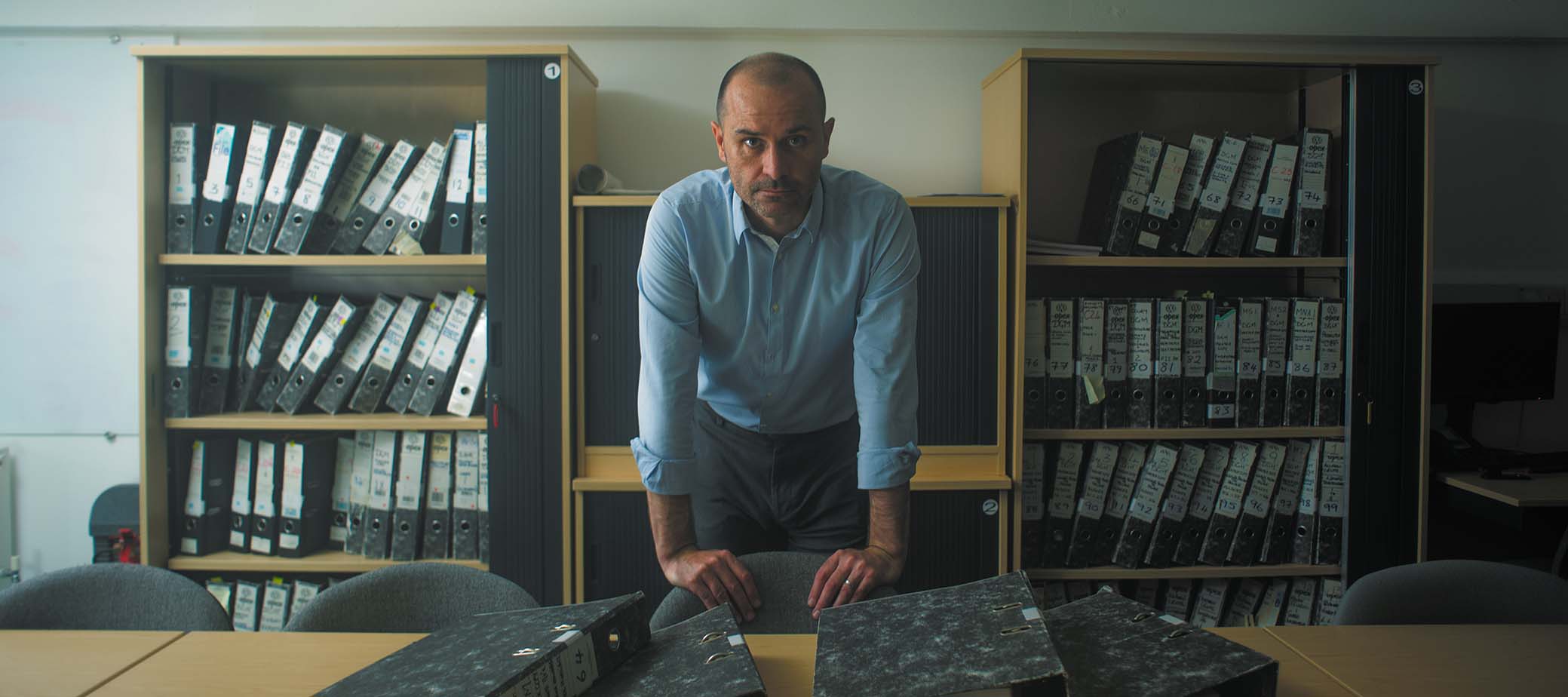 Brian Thornton standing behind a desk