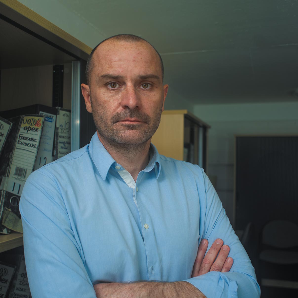 Brian Thornton standing behind a desk