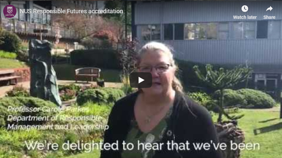 Video still of woman standing in a garden talking to camera