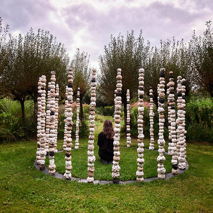 Man sitting inside circle of stomes