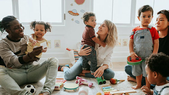 Group of mothers and toddlers playing on the floor