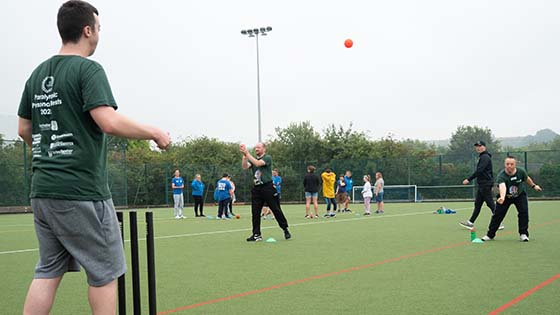 Particpants playing cricket