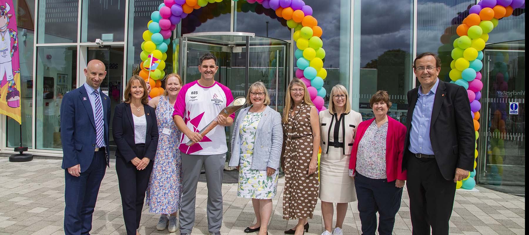 Grop celebrate arrivel of Baton outside the Leisure Park