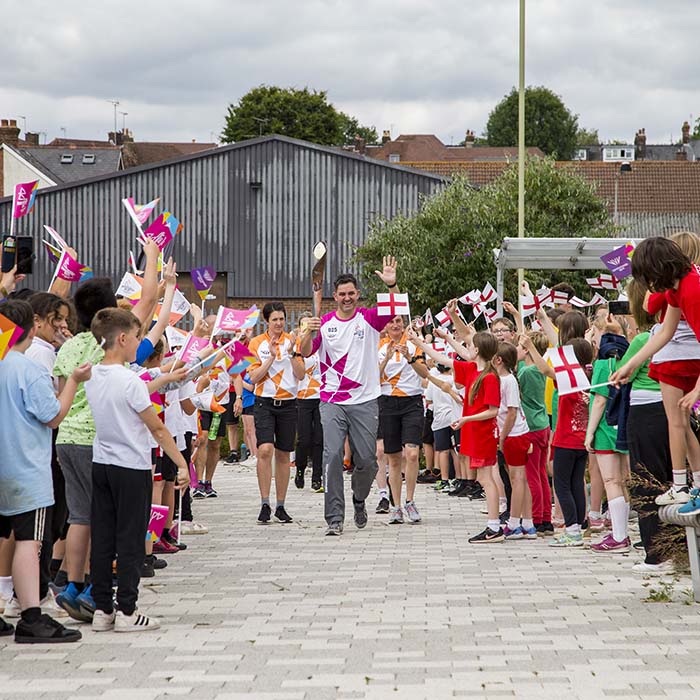 Grop celebrate arrivel of Baton outside the Leisure Park