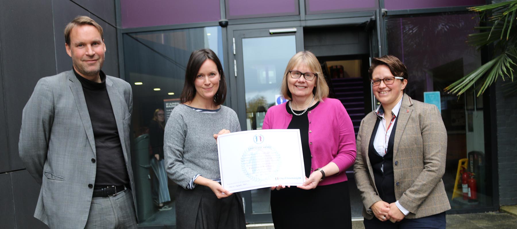 Professor Sarah Greer holds the University of Sanctuary award